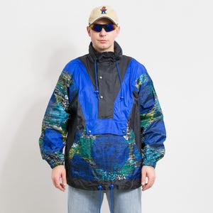 May include: A blue and black patterned jacket with a high collar and a drawstring hood. The jacket has a zipper closure and a snap button flap.