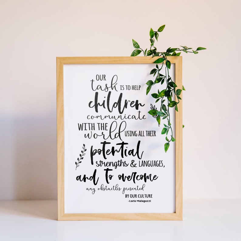 May include: A framed print with a white background and black text that reads "Our task is to help children communicate with the world using all their potential, strengths & languages, and to overcome any obstacles presented by our culture - Loris Malaguzzi".