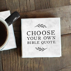 May include: Two white marble coasters with black text. The top coaster says "Choose your own Bible quote". The bottom coaster has a cup of coffee on it.