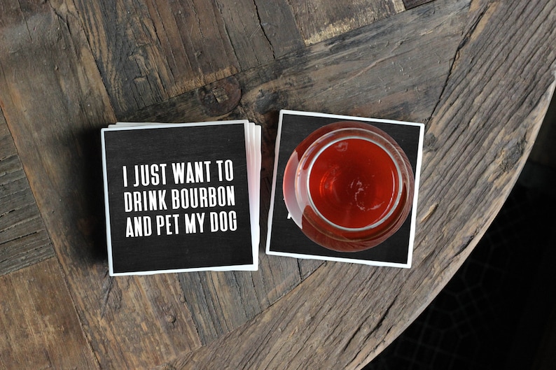 set of black and white costers, top one reads I just want to drink bourbon and pet my dog