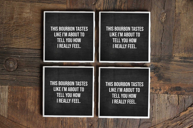 May include: Set of four black coasters with white text that reads "This bourbon tastes like I'm about to tell you how I really feel."