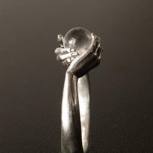 Sterling Silver Spinner Ring – Hands Holding Glass Orb, Calming Meditation Jewelry