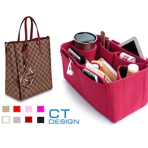 May include: A pink felt handbag organizer with multiple compartments for carrying items like a phone, wallet, and makeup. The organizer is shown inside a brown and tan checkered handbag.
