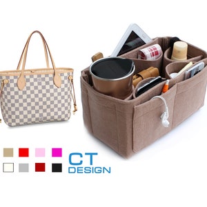 May include: A beige felt handbag organizer with multiple pockets and compartments. The organizer is filled with various items, including a phone, a tablet, a water bottle, and other accessories. The organizer is designed to fit inside a larger handbag, helping to keep the bag organized and tidy.