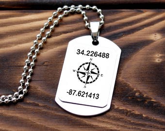 May include: Silver necklace with a silver dog tag pendant. The dog tag has a compass and the coordinates 34.226488 -87.621413.