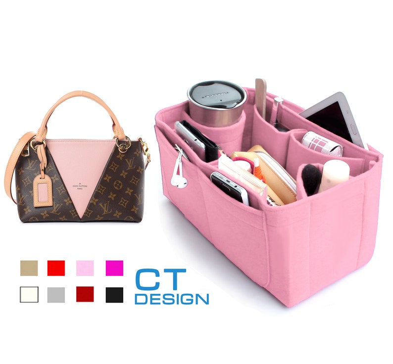 May include: Pink felt handbag organizer with multiple compartments for a purse. The organizer has pockets for phones, pens, makeup brushes, and other small items.