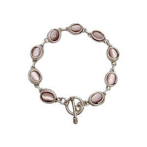May include: A silver bracelet with a toggle clasp and oval-shaped pink stones.