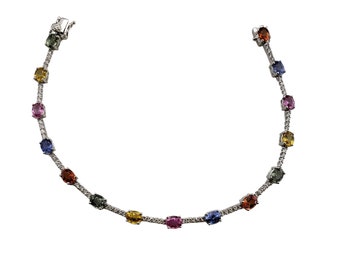 May include: A silver bracelet with a chain and oval-shaped gemstones in various colors, including blue, green, yellow, orange, and pink.
