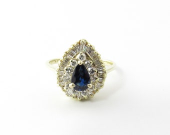 May include: A pear-shaped blue sapphire ring with a halo of smaller diamonds and a band of baguette-cut diamonds.