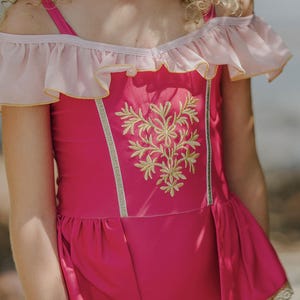 Sleeping Beauty inspired girls one-piece swimsuit with gold embroidered bodice and peplum waist