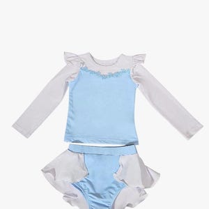 Cinderella-inspired long sleeve rash guard swimsuit for girls with floral neckline and princess blue one-piece design

Toddler princess swimwear in light blue with ruffles and full-length white sleeves, perfect for sun-safe beach days

One-piece girls swimsuit with long sleeves and ballgown-style peplum inspired by Cinderella, styled for fairytale pool fun