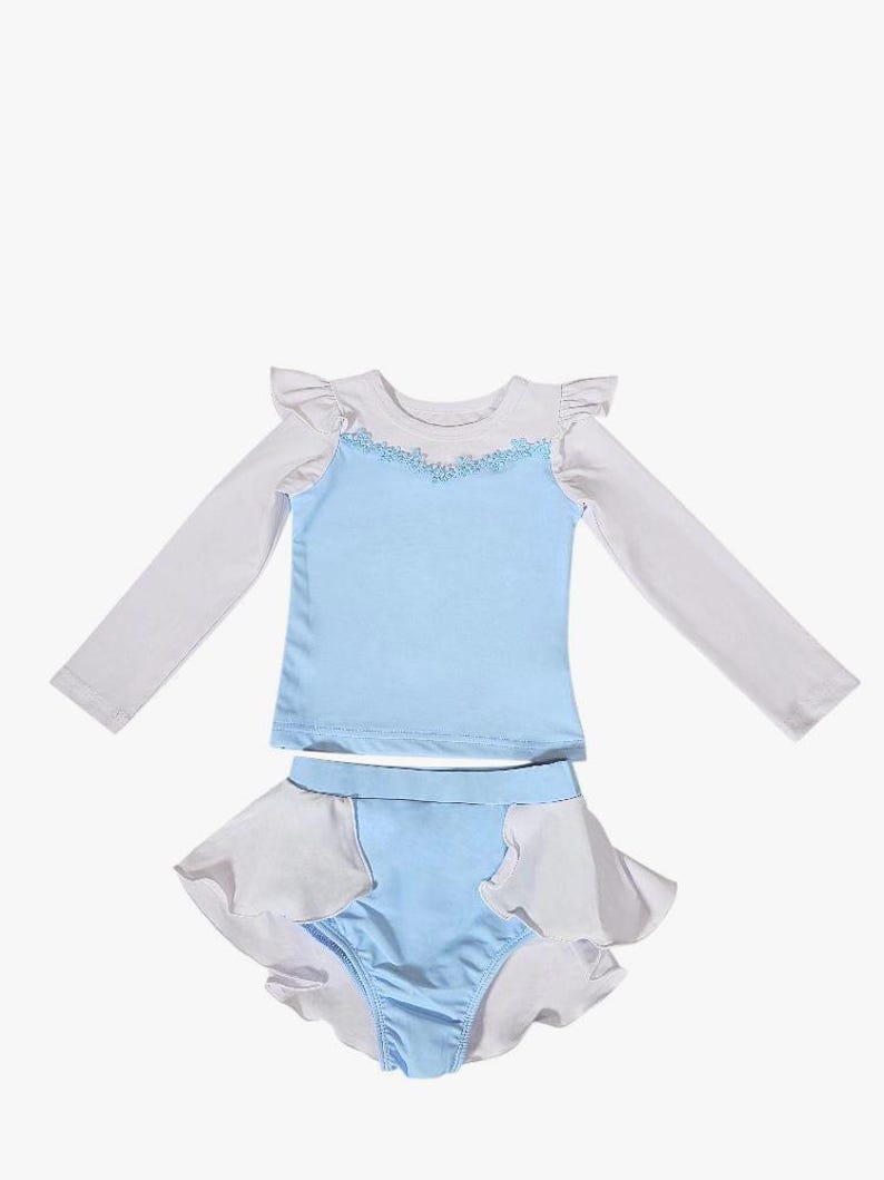 Cinderella-inspired long sleeve rash guard swimsuit for girls with floral neckline and princess blue one-piece design

Toddler princess swimwear in light blue with ruffles and full-length white sleeves, perfect for sun-safe beach days

One-piece girls swimsuit with long sleeves and ballgown-style peplum inspired by Cinderella, styled for fairytale pool fun