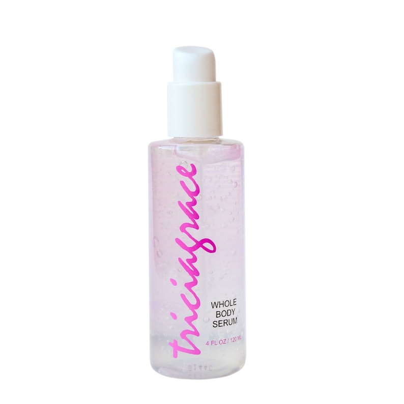 May include: A clear plastic bottle with a white pump dispenser. The bottle is filled with a clear liquid and has a pink label that says "virgin juice" and "whole body serum". The label also says "4 fl oz / 120 ml".