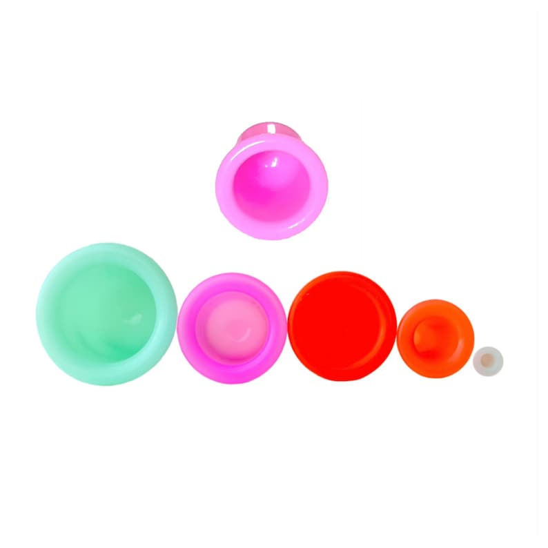 May include: Set of five silicone suction cups in various sizes and colors, including green, pink, red, and orange. The cups are designed for use in beauty and wellness applications.