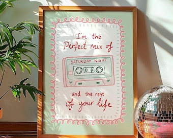 May include: A framed art print with a light green background and a pink border. The print features a cassette tape illustration with the words "I'm the Perfect mix of Saturday Night and the rest of your life."