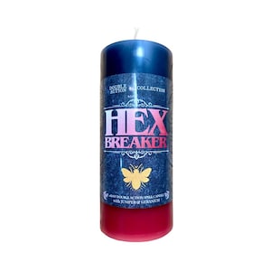 May include: A cylindrical candle with a dark blue top and a red base. The label reads "HEX BREAKER" in pink and white, with a gold butterfly illustration. The candle is a double-action spell candle with juniper and geranium.