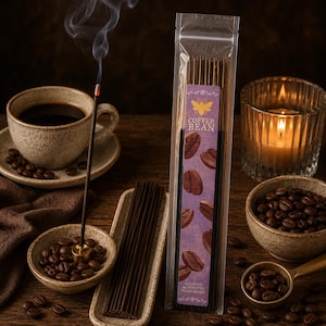 May include: A clear plastic package of coffee bean incense sticks with a purple label featuring a yellow bee icon and coffee bean illustrations. The label reads COFFEE BEAN and 20 COUNT 45 MINUTES PLANT-BASED. Dark incense sticks are visible.