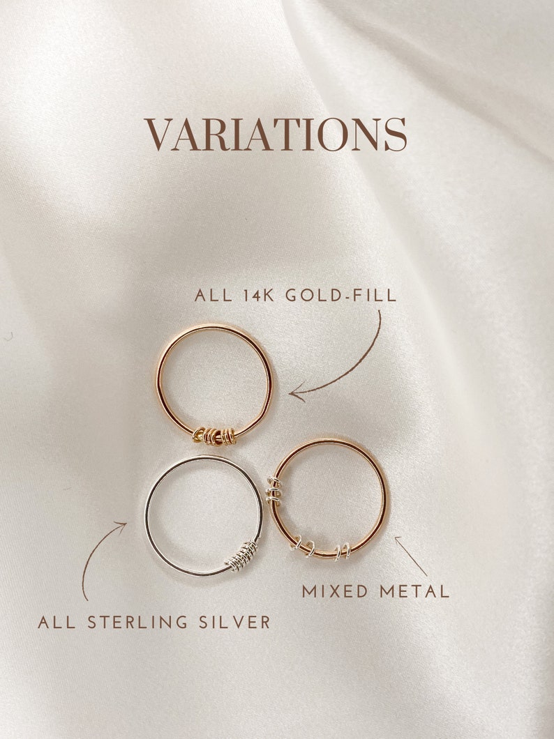 May include: Three variations of a simple ring with a twisted wire detail. The top ring is gold-filled, the middle ring is sterling silver, and the bottom ring is a mix of gold-filled and sterling silver. The text "ALL 14K GOLD-FILL", "ALL STERLING SILVER", and "MIXED METAL" are written below each ring.