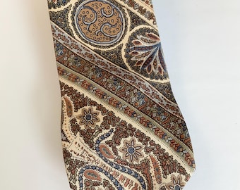 May include: A brown and blue paisley patterned tie with a cream background.
