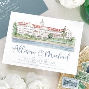 May include: A watercolor illustration of a wedding invitation with a light blue background. The invitation features a watercolor painting of a building with red roofs and white walls. The text on the invitation reads "Allison & Michael are getting married September 20, 2022 The Colony Hotel Kennebunkport, Maine".