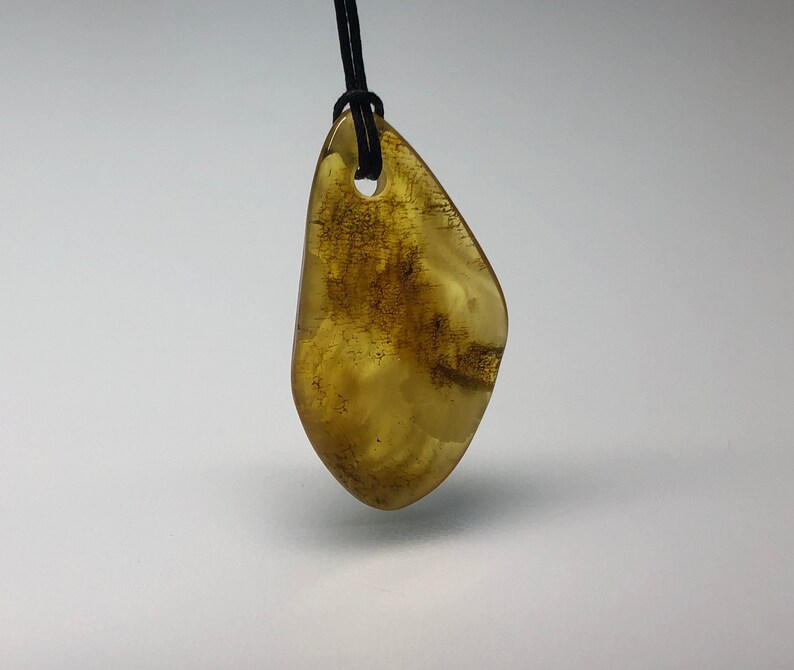 Genuine Baltic Amber pendant on string.