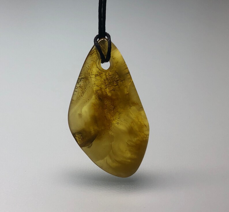 Genuine Baltic Amber pendant on string.