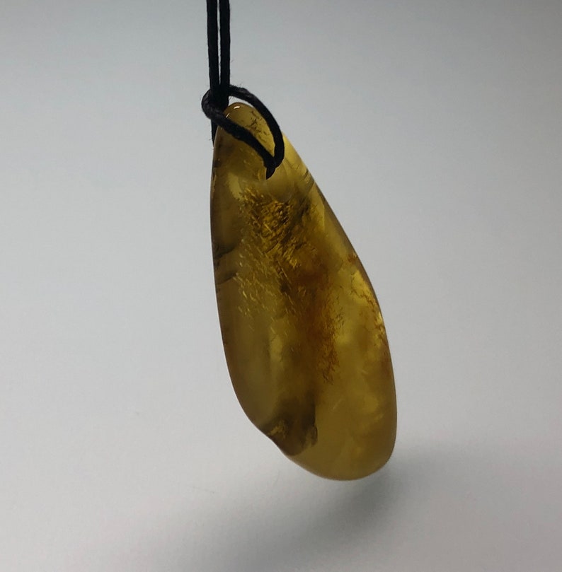 Genuine Baltic Amber pendant on string.