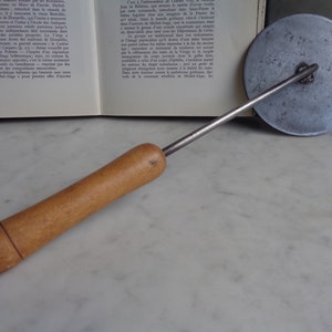 old wooden and metal utensil, vegetable press, cast aluminum disc, retro kitchen decor, vintage French