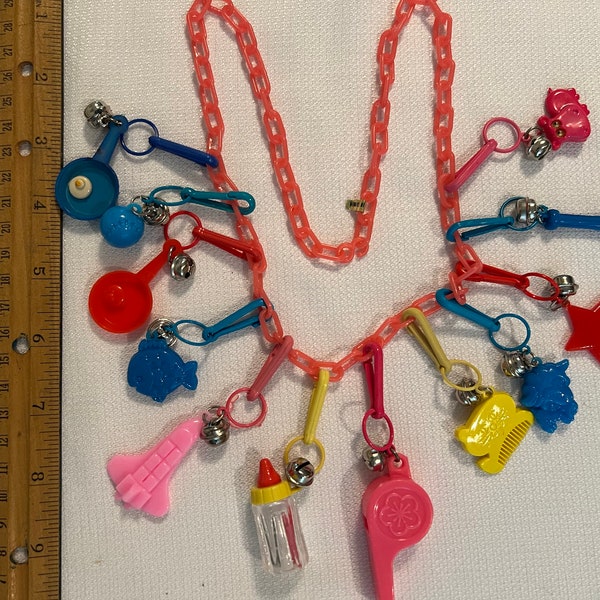 Vintage plastic bell 24 inch necklace 1980’s multi colored  / hippo baby bottle fish fighter plane star cat-comb egg frying pan bat pink