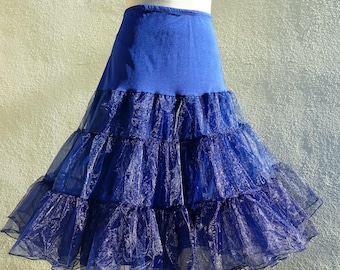 May include: A blue tulle petticoat with multiple layers. The petticoat has a solid blue waistband.