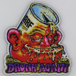 May include: A colorful embroidered patch with a cartoon image of a red-faced person with a can on their head. The can is labeled "ARF" and the text "DRUNK AGAIN" is written in purple, pink, and white letters.