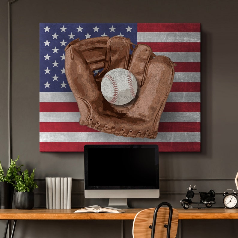 May include: A brown leather baseball glove with a white baseball inside, against a backdrop of an American flag.