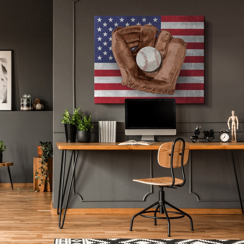 May include: A brown leather baseball glove with a white baseball inside, on a canvas print of the American flag.