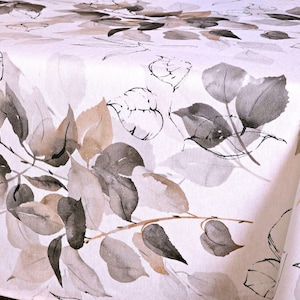 May include: A white tablecloth with a watercolor design of leaves in shades of gray, brown, and beige. The leaves are arranged in a natural, organic pattern, creating a soft and elegant aesthetic. Ideal for dining or special events.