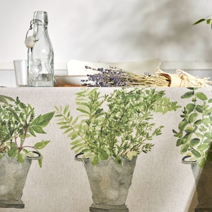 May include: A beige linen tablecloth with a green botanical print featuring various herbs and plants in galvanised metal pots. The tablecloth has a rustic and farmhouse style.