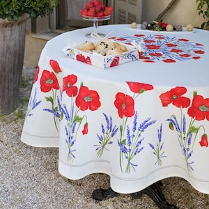 May include: White round tablecloth with a red poppy and lavender floral pattern. The tablecloth is on a round table with a basket of pastries and a bowl of strawberries.
