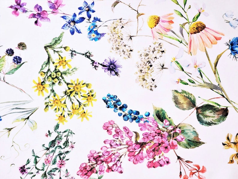 May include: A watercolour floral print featuring a variety of flowers in shades of pink, yellow, blue, and white. The flowers are arranged in a random pattern on a white background.