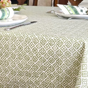 May include: A green and white tablecloth with a geometric pattern. The tablecloth is made of a soft, durable fabric and is perfect for any occasion.