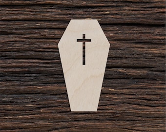 May include: A wooden coffin cutout with a cross on a dark brown wood background.