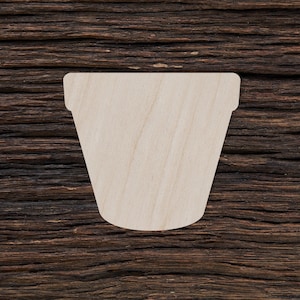 Può includere: Un ritaglio di legno di un vaso di fiori su uno sfondo di legno marrone.