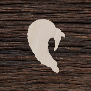 May include: A white wooden cutout of a turkey on a dark brown wood background.
