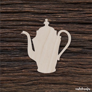 May include: A wooden cutout of a teapot with a lid and a handle. The cutout is a light brown colour and is on a dark brown wooden background.