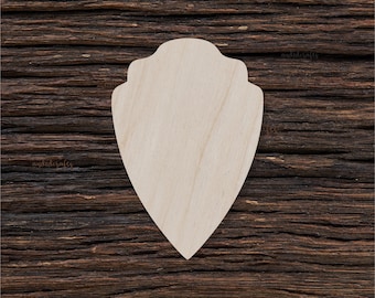 May include: A wooden cutout of a shield shape with a slightly pointed bottom and a rounded top. The shield is made of light-coloured wood and has a smooth surface.