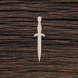 May include: A white wooden cutout of a dagger shape against a dark brown wood background.