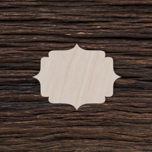 May include: A white wooden frame with a decorative, scalloped edge, set against a dark brown wood background.