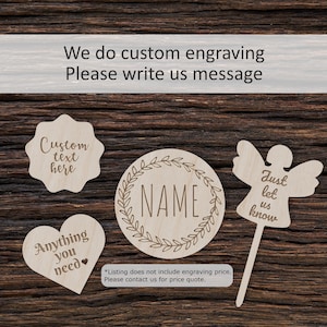 May include: Four wooden shapes with customizable text options for engraving. The shapes include a heart, a circle with a wreath, a star, and an angel. The text on the shapes reads "Anything you need", "NAME", "Custom text here", and "Just let us know".