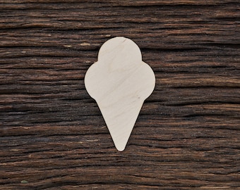 May include: A white wooden ice cream cone cutout on a dark brown wooden background.