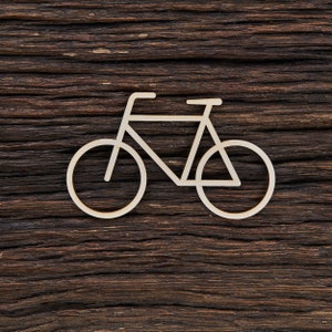 Könnte beinhalten: Eine weiße Fahrrad-Silhouette aus Holz, vor einem dunkelbraunen Holz Hintergrund.