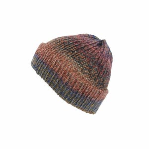 May include: A knit beanie featuring a variegated colour pattern with blended tones of rust orange, deep blue, and dark brown. The hat is constructed with a ribbed texture throughout, including a folded cuff at the base, creating a thick appearance.