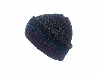 May include: A dark navy blue knit beanie with a folded cuff. The yarn features subtle, multi-colored flecks of red, green, and yellow throughout the ribbed texture, creating a variegated appearance across the entire surface of the winter hat.